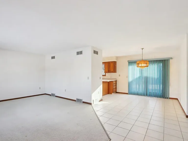 Living room and dining. Light fixture and curtains are no longer there. Fresh paint.