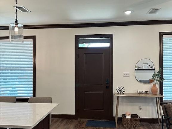 Looking towards the front door, via the long hallway