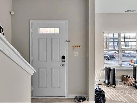 From inside the home looking at the front door. You can see the stairs going up on the left and part of the office on the right