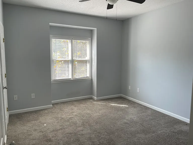 The front bedroom has two large windows for great light and a ceiling fan to help keep things cool.