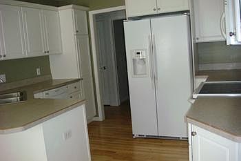 Kitchen with loads of cabinets and countertops, all the appliances stay as well.