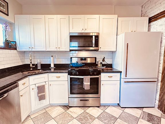 Gas stove with counter depth refrigerator.