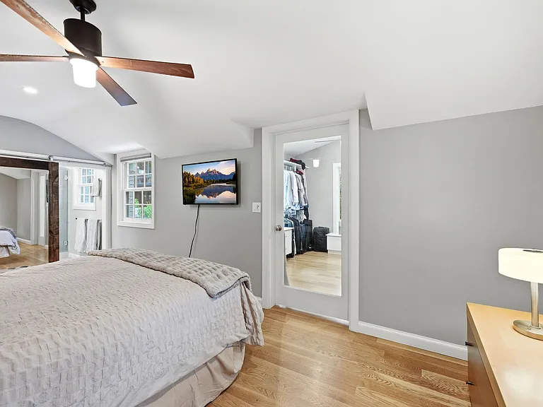 Master bedroom with exposed brick wall, ensuite bathroom and large walk-in closet.