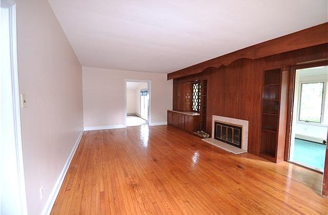 Large living room has a wood-burning fireplace