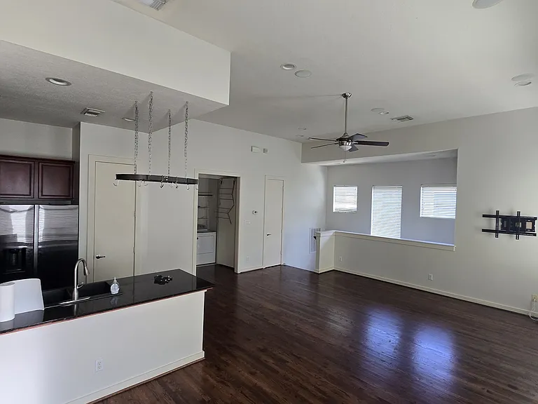 Upstairs living room and open kitchen is open with lots of windows for natural light. There is a half bathroom.
