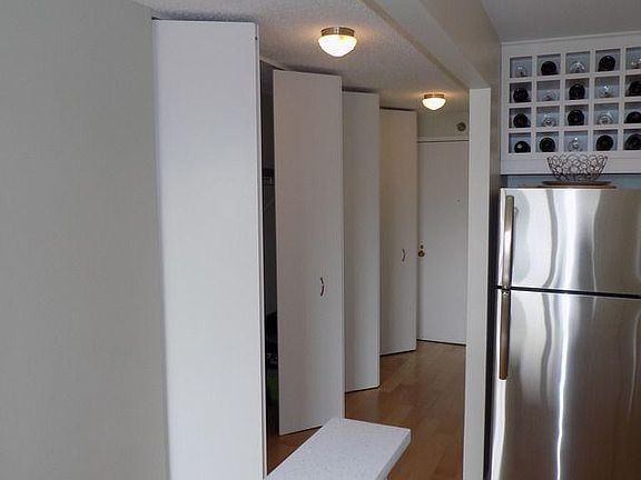 Entry hallway - includes three double panel closets - the middle one includes a built in desk.