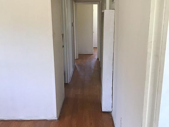 Hall view - 2 bedrooms on left, 1 bedroom in right rear corner.