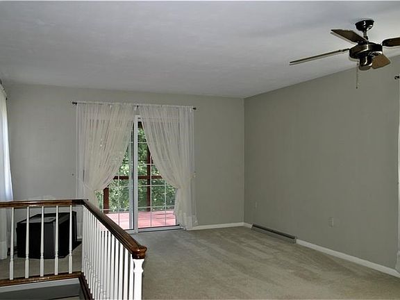 The Living Room is calming in its color scheme and opens to the rear covered and screen-in rear deck!