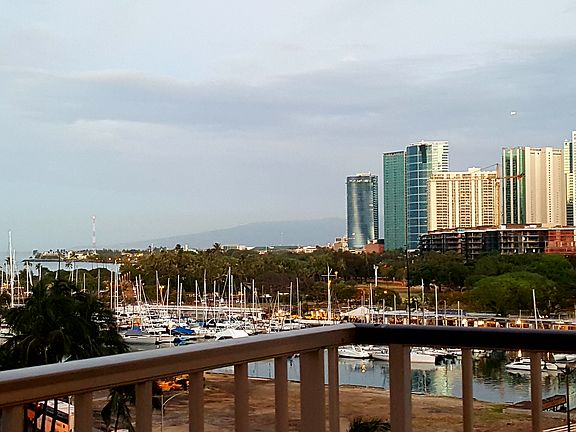 Ocean side Patio with Ala Moana Beach Park and Ala Moana Shopping Center (right side). Ala Wai Yacht Harbor with Boat Landing.