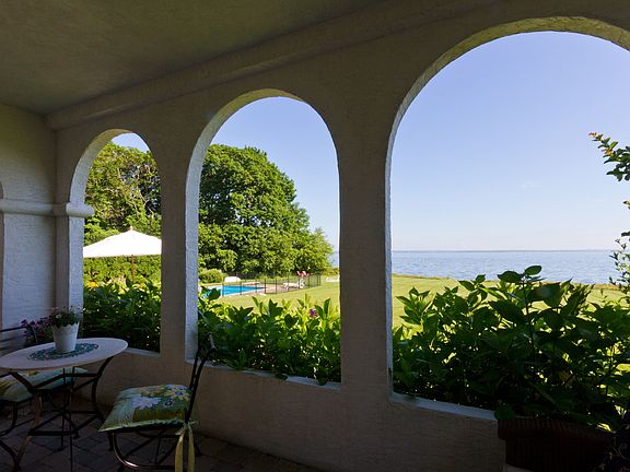 View of pool and LI Sound from covered terrace.