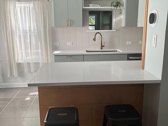 View from front living room into kitchen. Pass through window above the sink gives great view of the backyard while doing dishes.