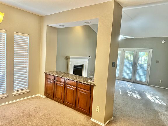 Dining room and Living Room separated by a row of wood cabinets