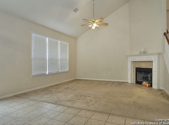 Living room w/high ceilings and cozy fireplace.