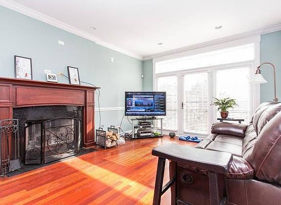 Sun-drenched living room with wood fireplace