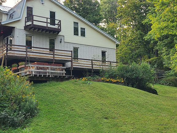 side of house and hot tub