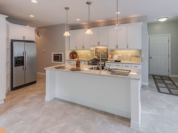 Kitchen and view of family room.  New appliances, gas stove all are staying as viewed.