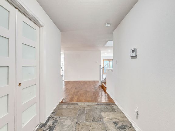 Entry way with office on the left, leading to the formal dinning area, kitchen and living room