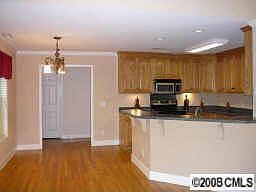 open floor plan features breakfast area and bar