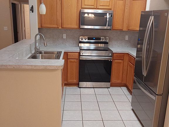 Kitchen with Stainless Steel Appliances, Refrigerator with bottom freezer and ice maker, Free standing Stove, Dishwasher, Microwave.
