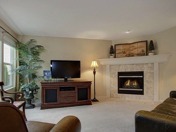 Family room off of kitchen has gas fireplace and large windows for natural light!
