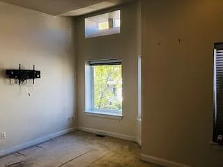 Main bedroom with TV wall mount installed. Master bedroom has vaulted ceiling and oversized main window.