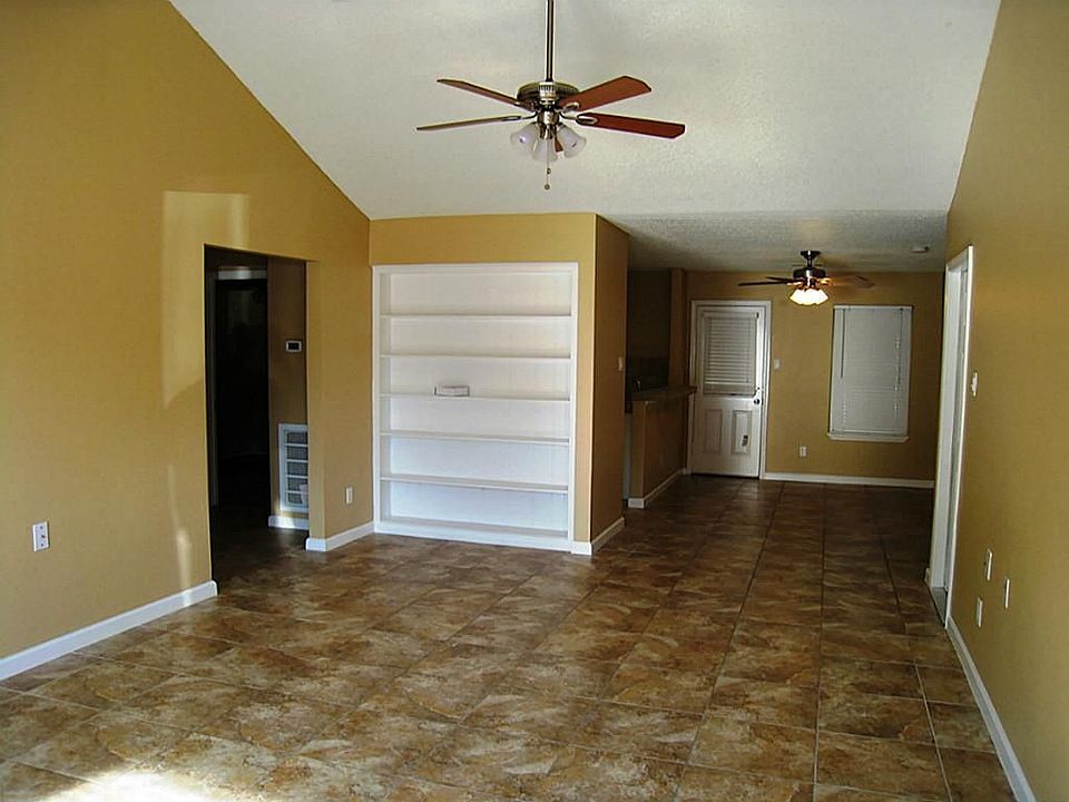  Large family room, tile floors and new ceiling fan plus built in shelving