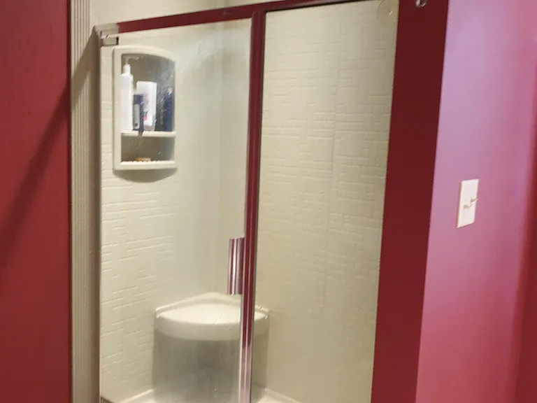 Master bath with large walk in shower with rainwater shower head and standard shower head