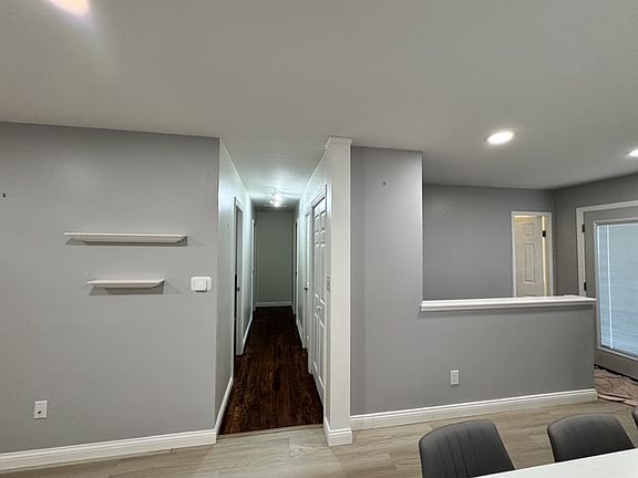 Hallway to bedrooms and stairs to basement