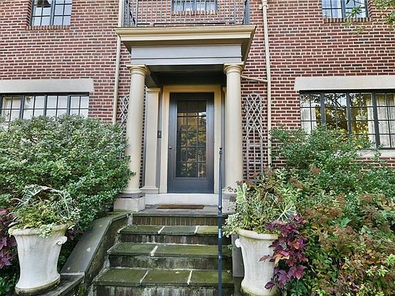 All brick home has stately entrance.