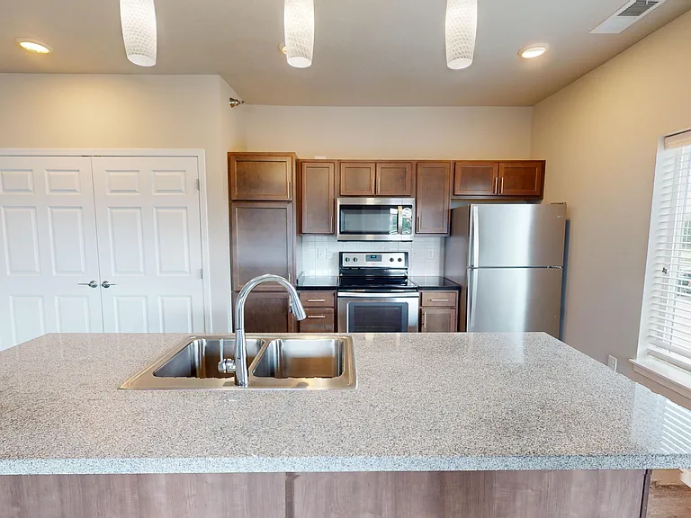 Kitchen highlights include granite countertops, with some homes featuring a breakfast bar or kitchen island.