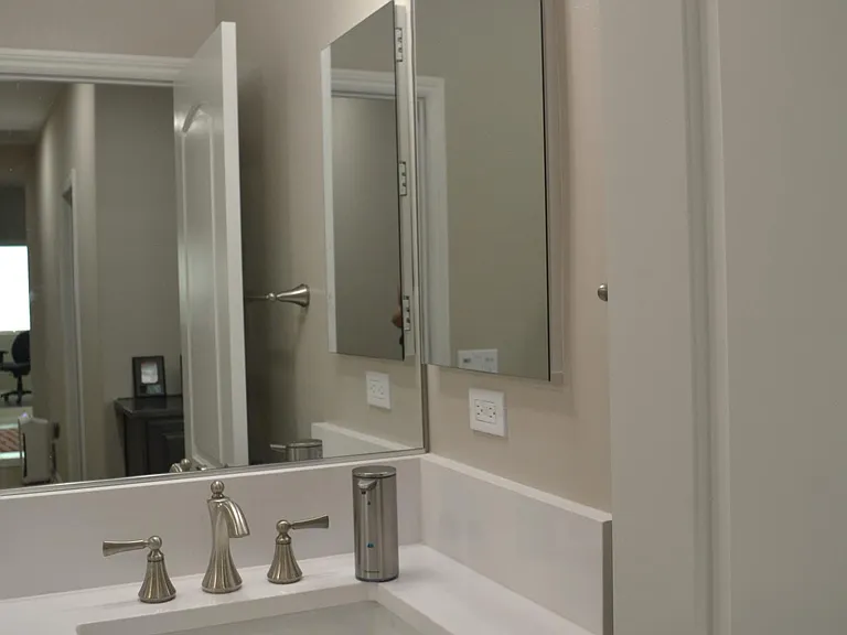 Bathroom 2 - single sink, quartz countertops, mirrored medicine cabinet.