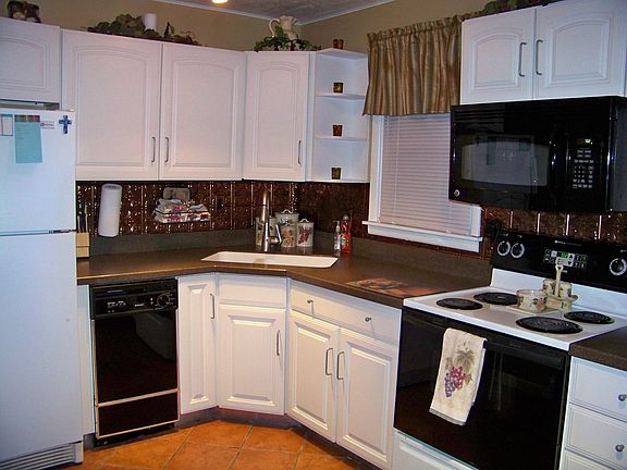 Updated corian countertops and Tuscan copper backsplash