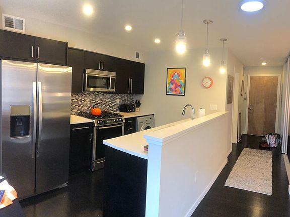 Large galley kitchen with Bosch dishwasher and gas stove, LG washer/dryer, extra large stainless sink. Plenty of storage, including large pantry closet next to refrigerator.