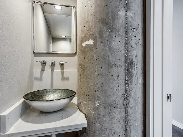 Convenience meets style in the downstairs vanity bathroom, a perfect powder room for guests, featuring elegant fixtures and a refined design.