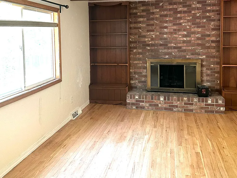 Family room facing fireplace and bookcases