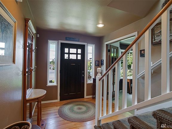 The home features a beautiful front door, and added light from a skylight above the stairs.