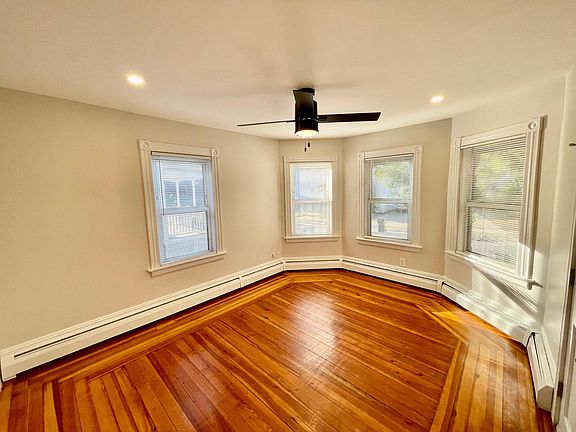 Living Room - Bay windows, recessed lighting, hardwood flooring