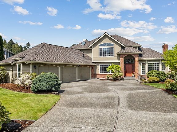 Let's walk up the step to the this gorgeous home with 50 year roof and wood siding. The landscaping has been tended to continue to provide much enjoyment in the future! 