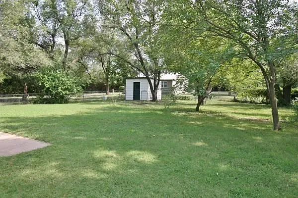 Fenced yard with shed