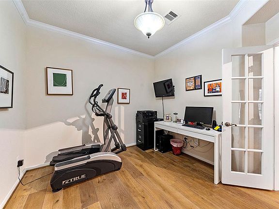 The high end wood flooring carries through to the study and also includes crown molding and its own closet!
