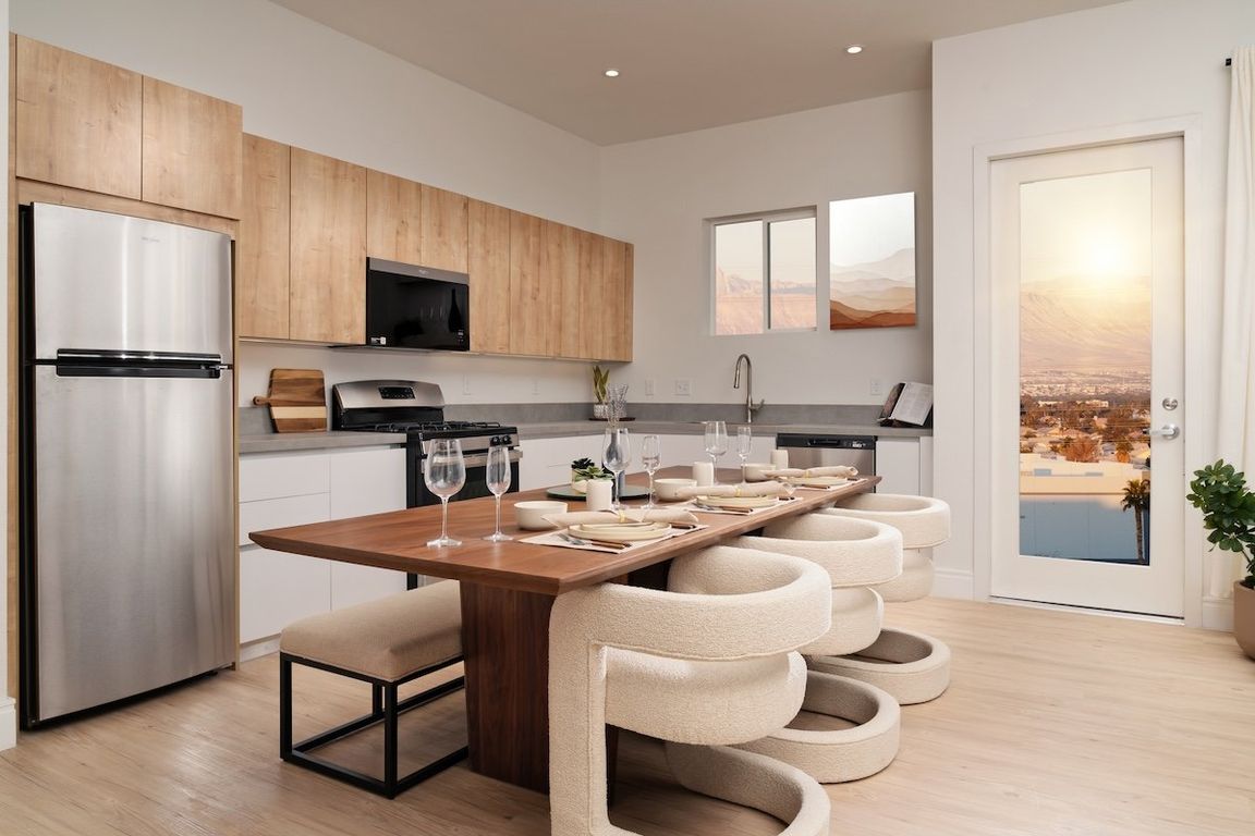 Apartment kitchen and dining area at Otonomus Las Vegas
