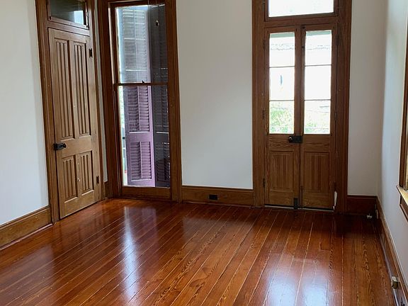 bedroom w/ closet and french doors to front balcony