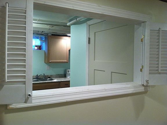 Shutter window between bedroom and kitchen