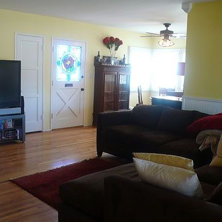 Living Room showing front door with stained glass and part of Dining Room.