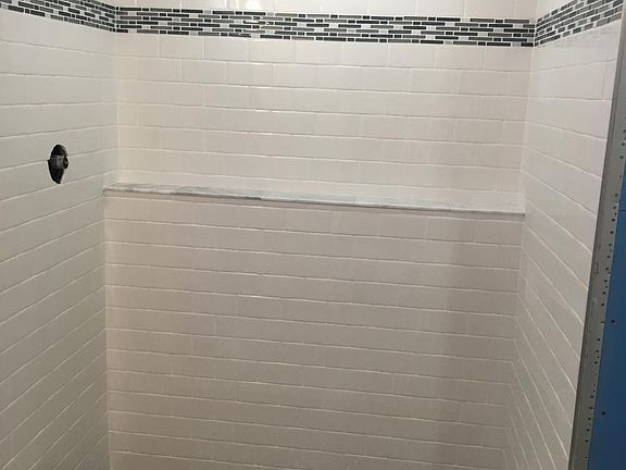 New glassed in shower with modern tile~
