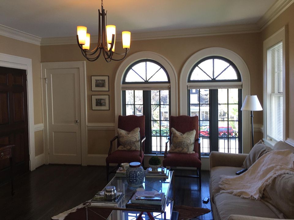 beautiful new roll out palladian windows provide lots of interior sunlight and uptown skyline view