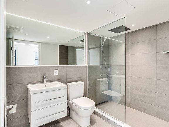 Luxury bathroom with spa inspired shower and extra large mirror