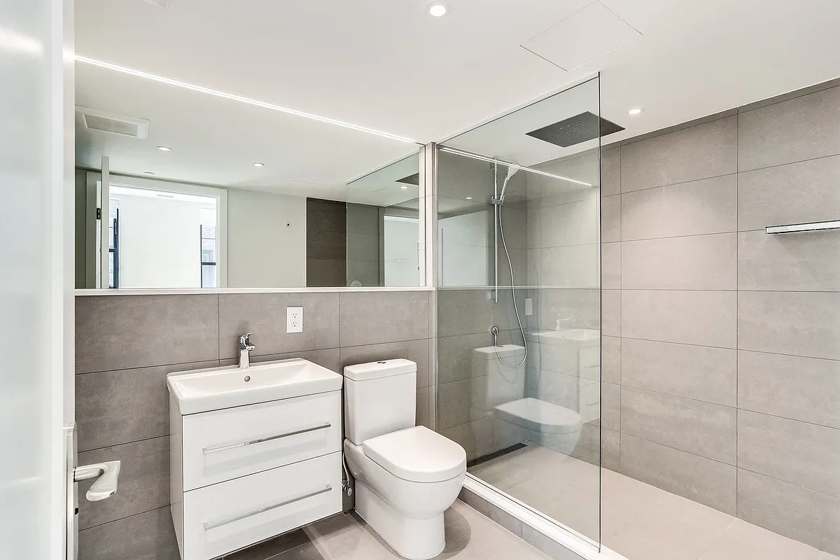Luxury bathroom with spa inspired shower and extra large mirror - The Stanton