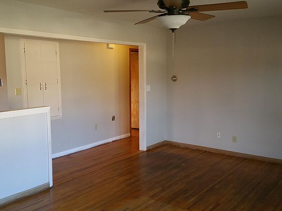 Large, open-concept living room with hardwood floors.
