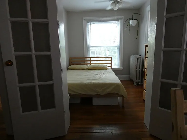 bed area with doors open